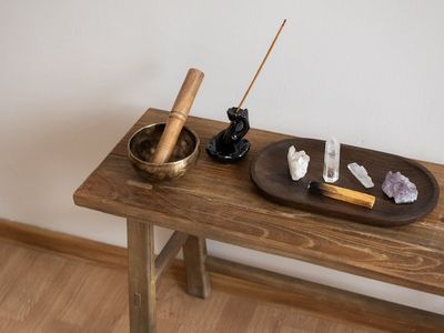 Meditation bowl and incense sticks on wooden floor